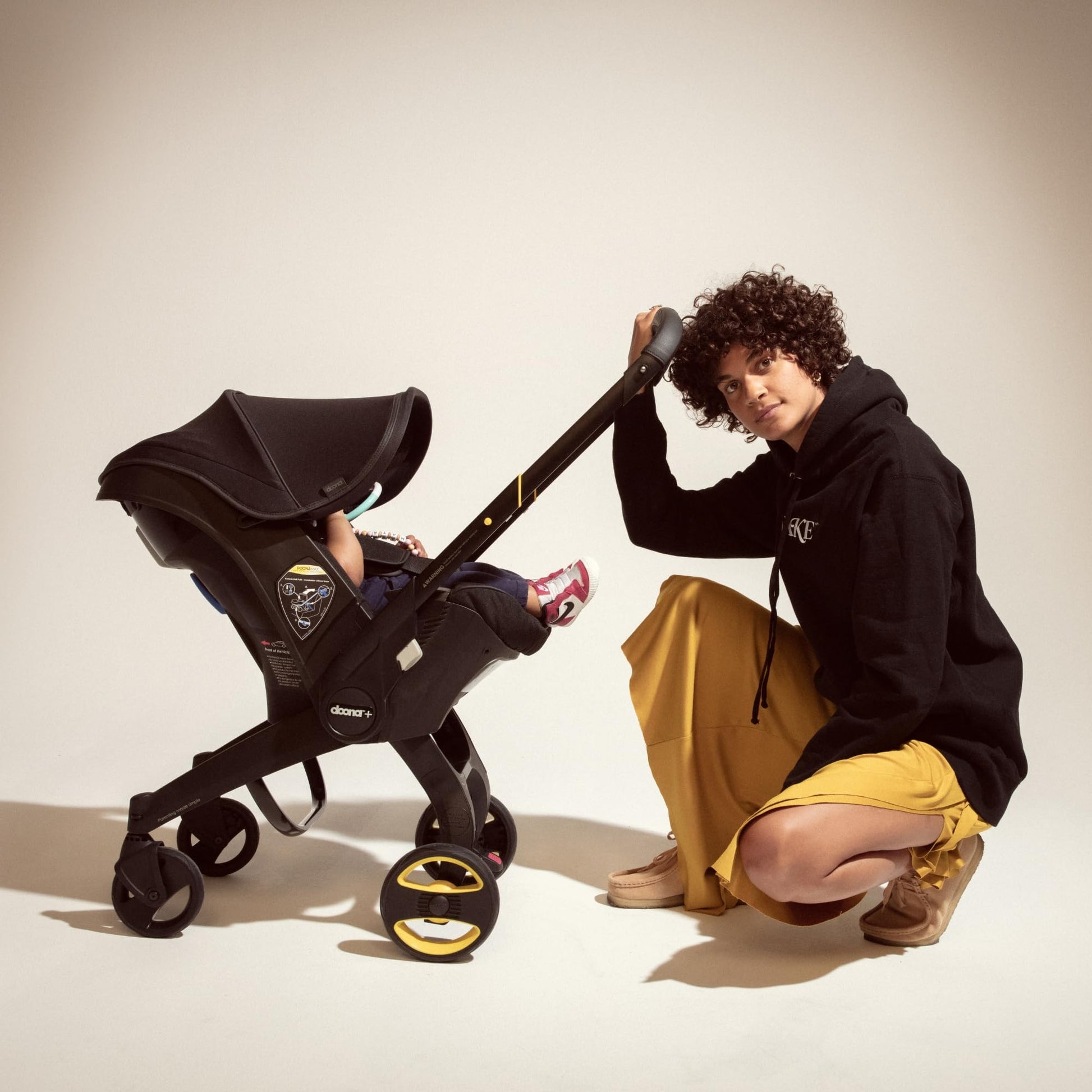 My Store Doona car seat and stroller in slate green, all-in-one travel system with a compact design and easy fold feature.