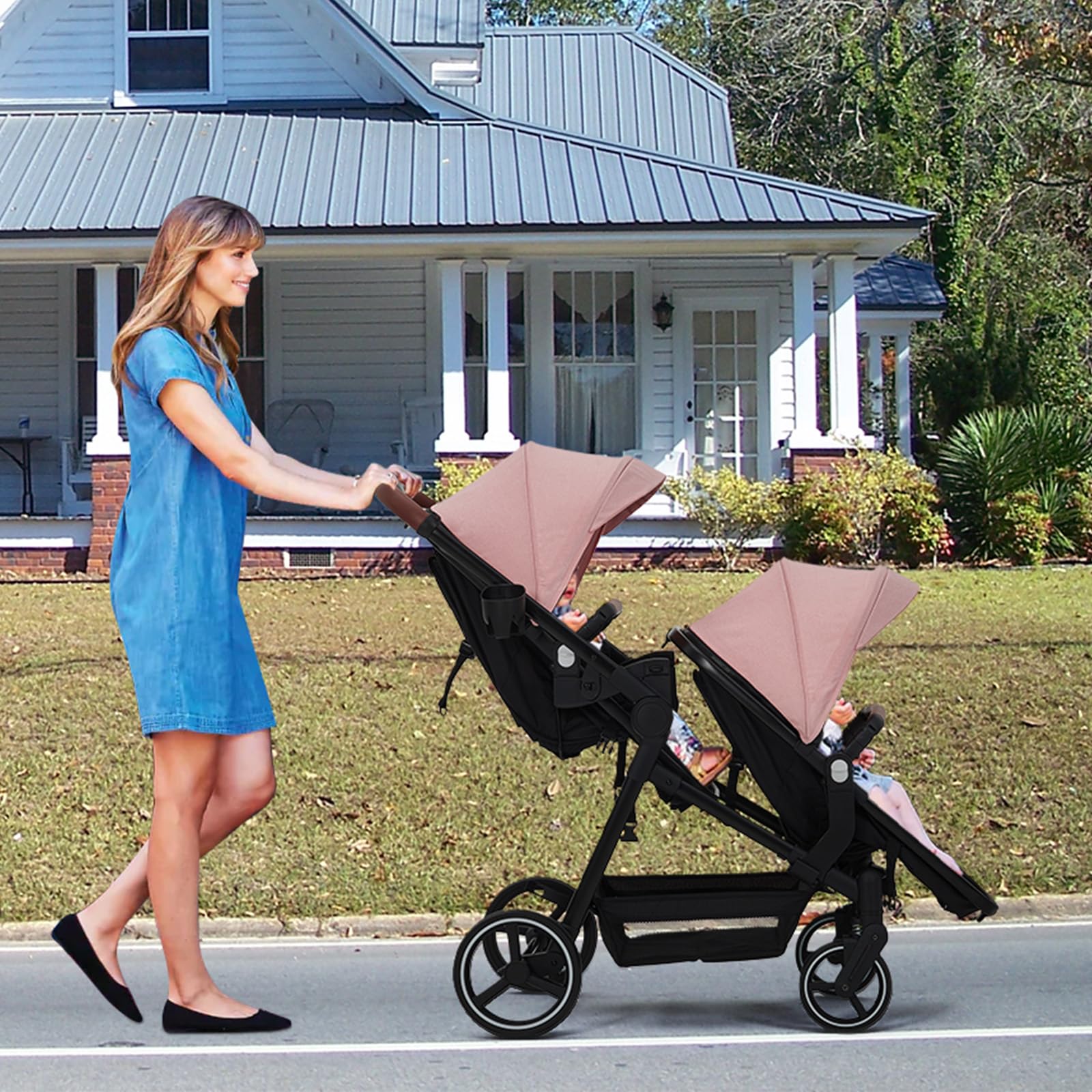 Black tandem stroller with reversible seats, adjustable canopies, one-hand fold, large storage basket for newborn and toddler twins.