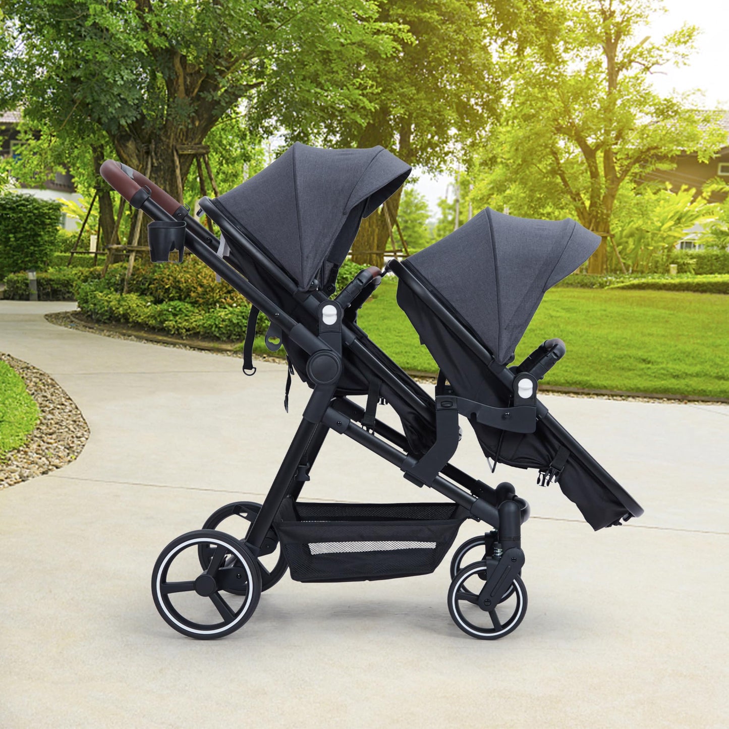 Dark grey tandem double stroller for newborn and toddler with reversible seats, adjustable canopy, 5-point harness, and large storage basket.