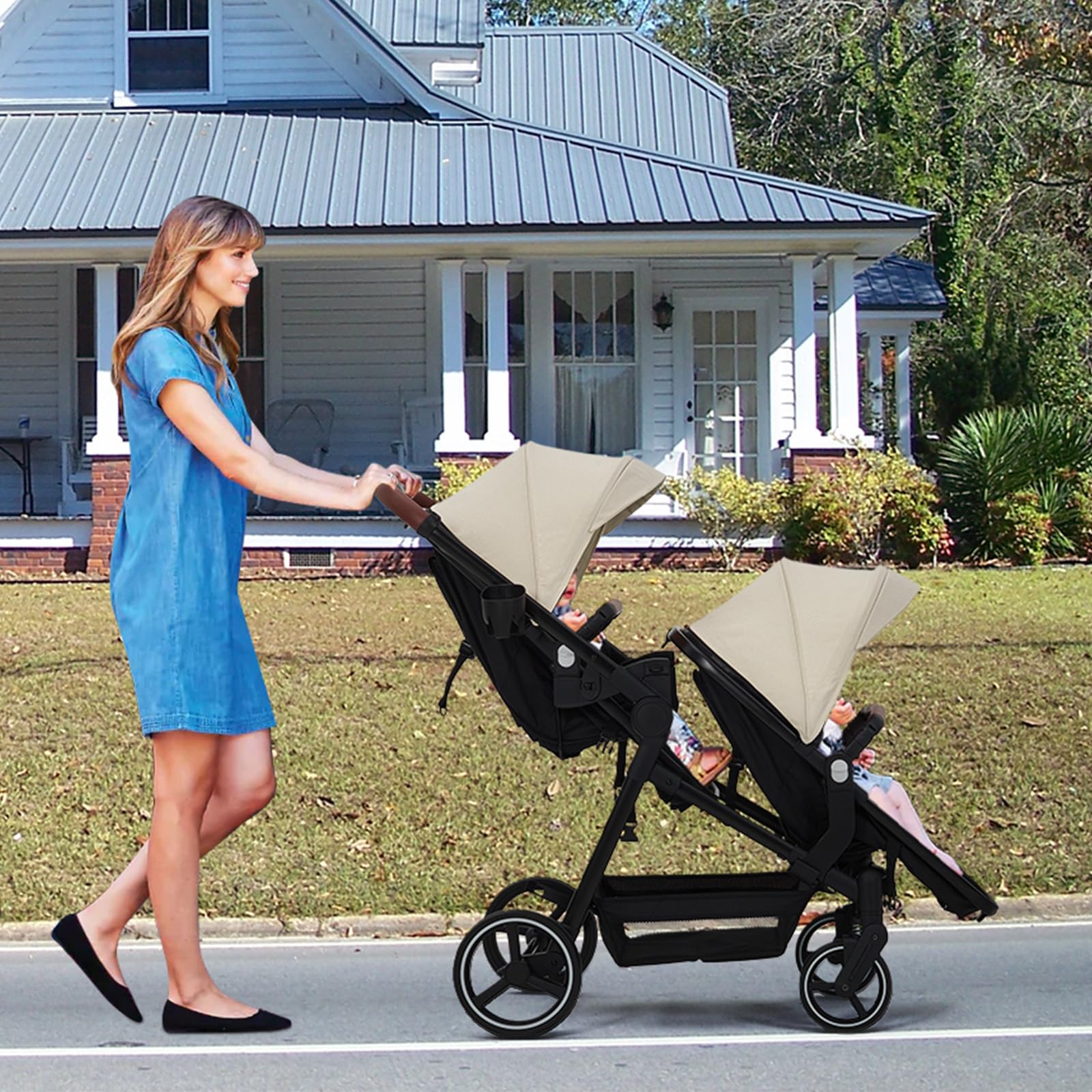 Black tandem stroller with reversible seats, adjustable canopies, large storage basket, and one-hand fold for twins and newborns.