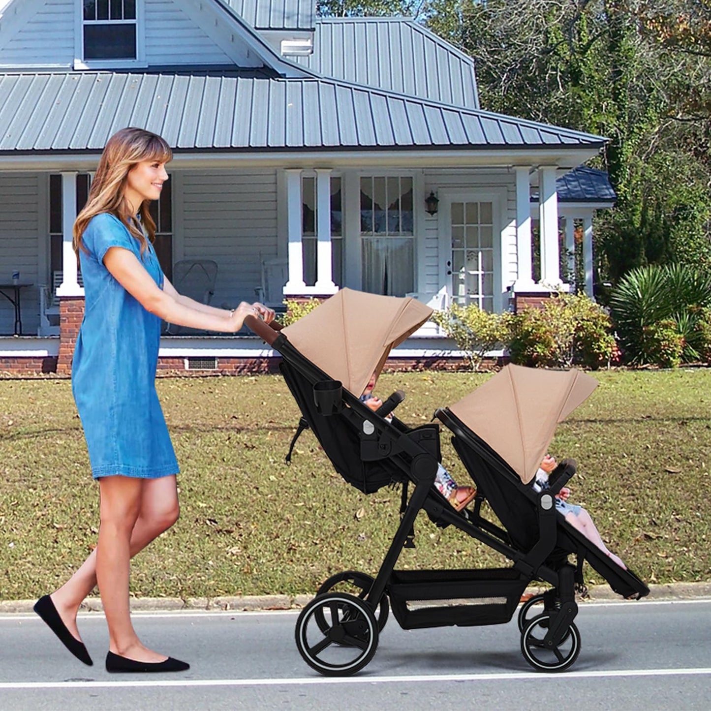 Dark grey tandem double stroller for newborn and toddler, with reversible seats, adjustable canopy, 5-point harness, and large storage basket.
